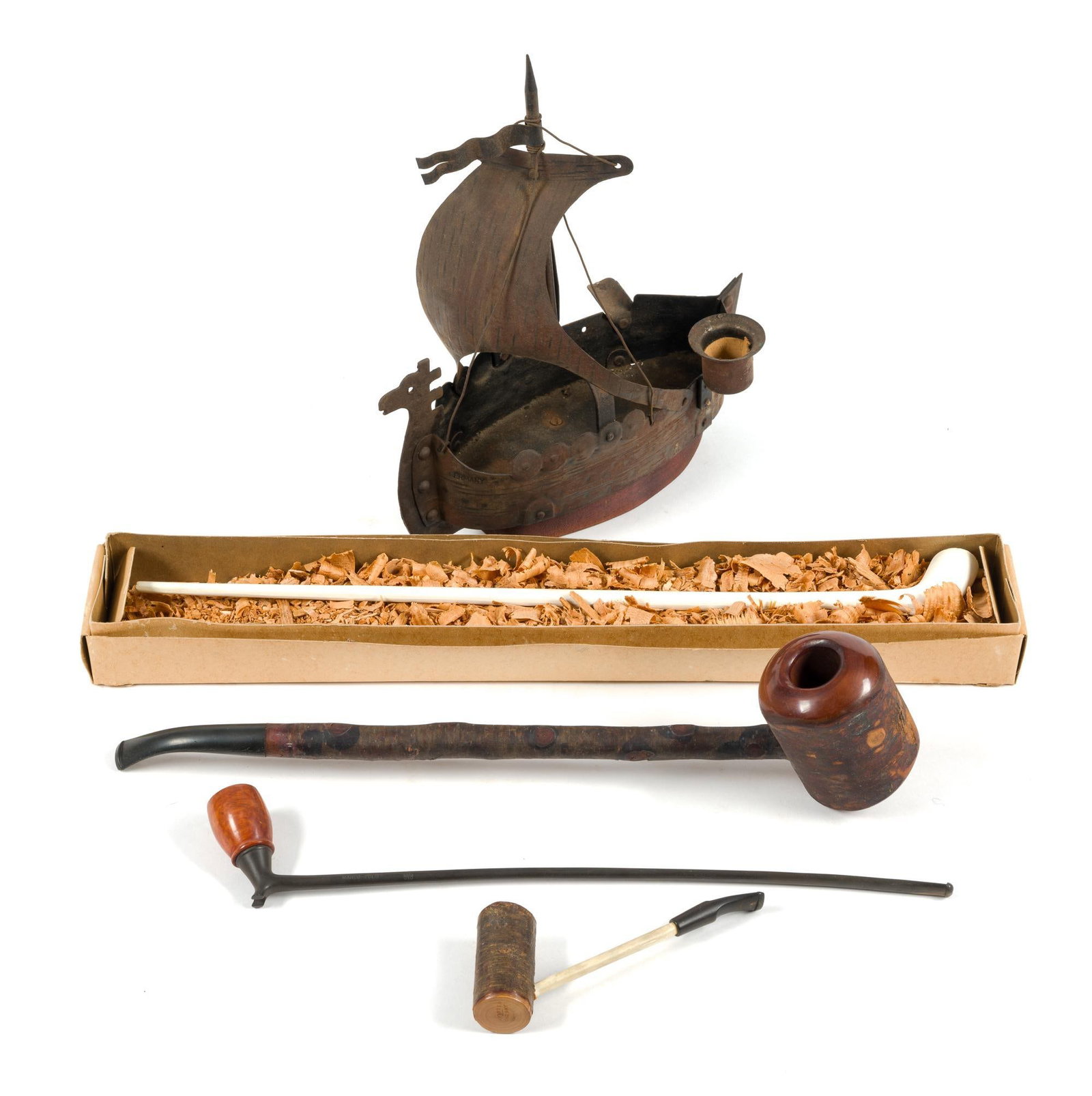 4 Pipes & 3 Canes: Also includes a vintage cigar smoking stand in the shape of a Viking ship. Longest cane measures 34". Includes 3 briar pipes and a clay pipe. 
