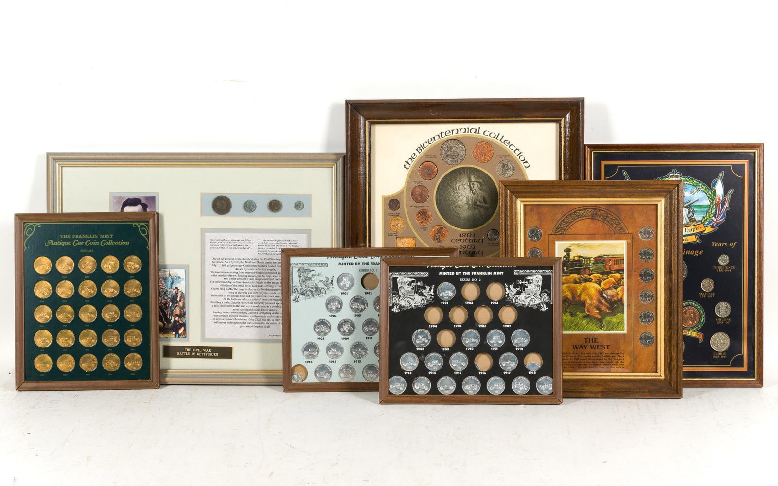 7 Framed Commemorative Coins & Tokens: Includes Franklin Mint Antique Car Coin Collection; The Way West; The Royalty & Empire Collection; 4 Civil War Era coins; and The Bicentennial Collection. 8-1/4" to 13-1/4" long x 10-1/4" to 17-3/8"