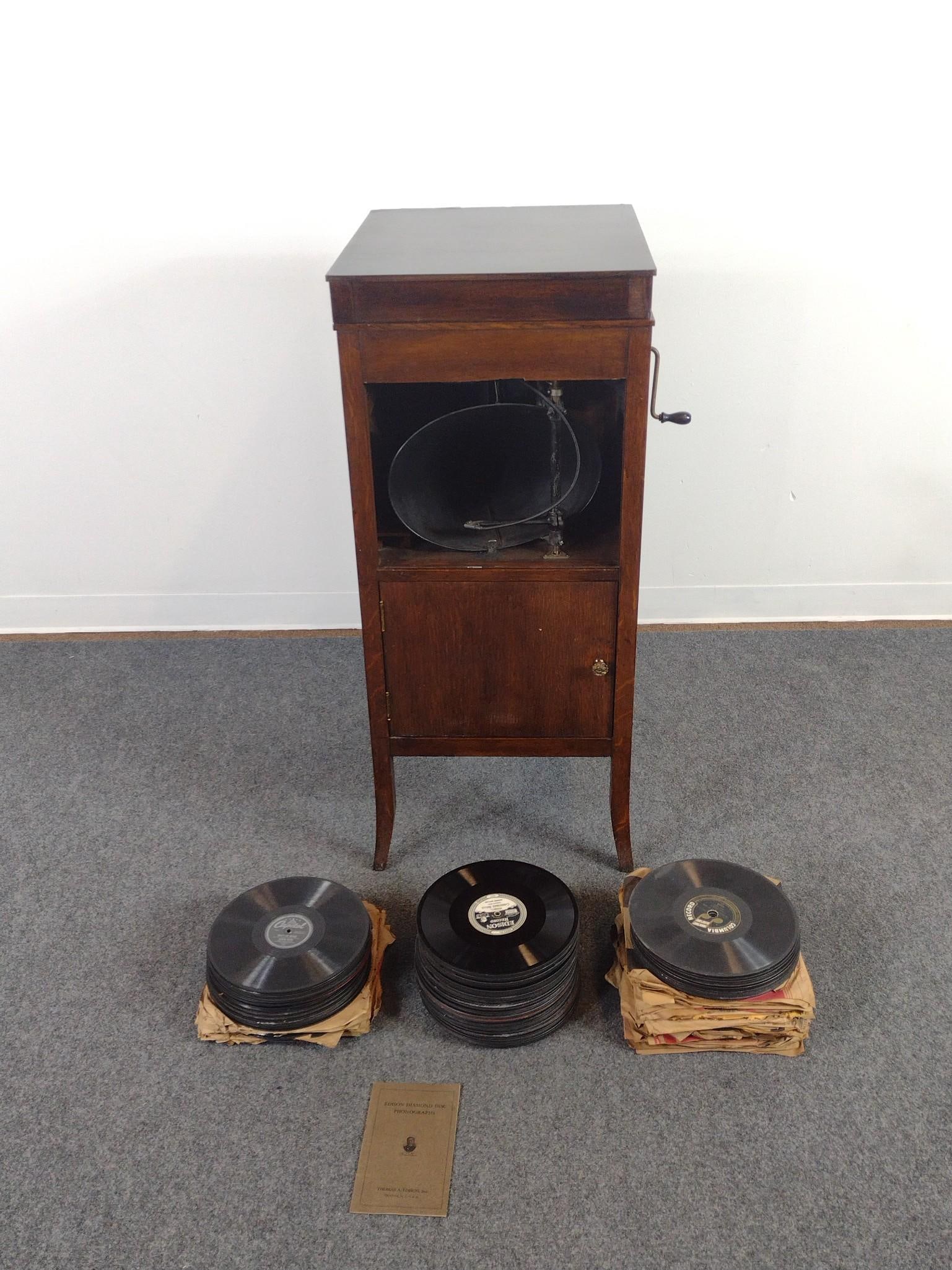 Edison Victrola With Records: 18" wide X 20-1/2" deep X 41-1/2" high. Missing front grill. Has some scratches.