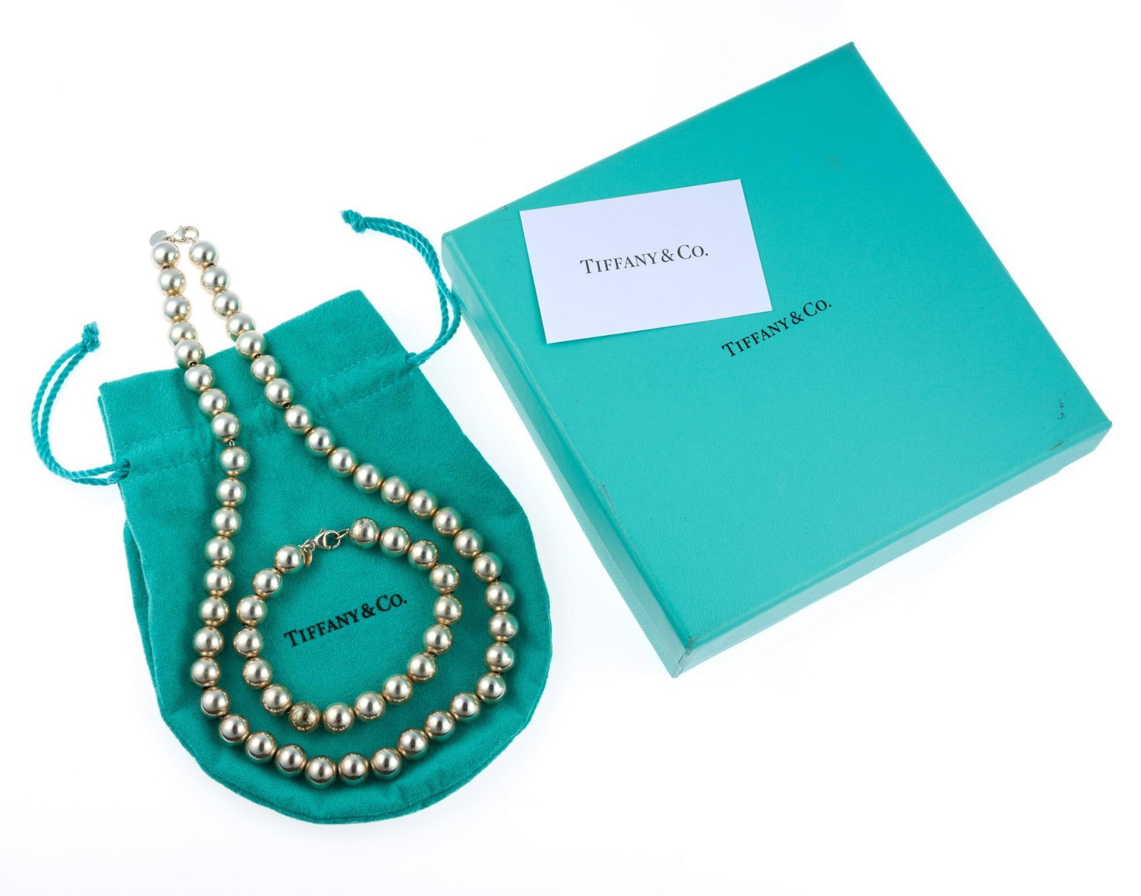 Tiffany & Co Sterling Silver Bead Necklace and Bracelet: A 7" Tiffany sterling bead bracelet and matching 18" necklace. The set comes in the original Tiffany pouch and outer box. They weigh 2.1 troy ounces in total.