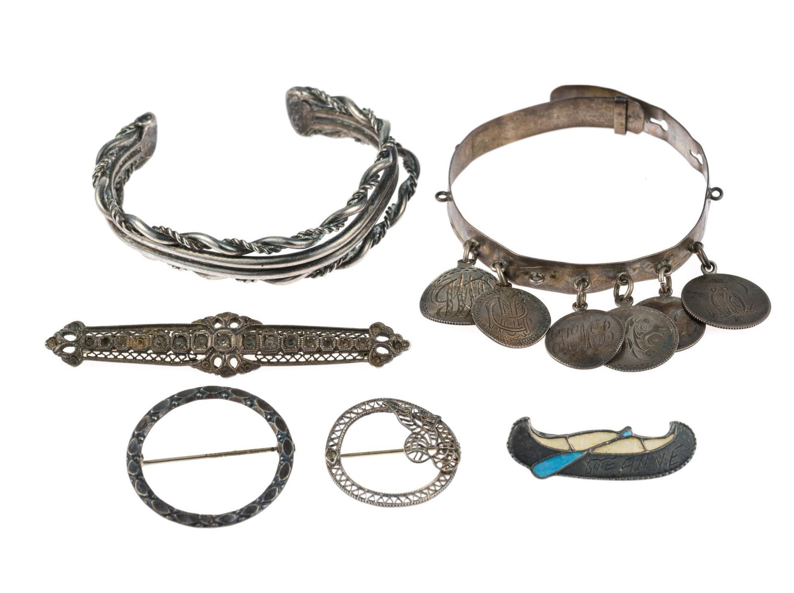 Vintage Sterling Silver Jewelry: Some pieces are marked and others are not. The canoe pin is Saint Anne (Sainte Anne De Beaupre, Quebec) made by BMCo Breadner Manufacturing Co. of Ottawa. The primitive charm bracelet is from the