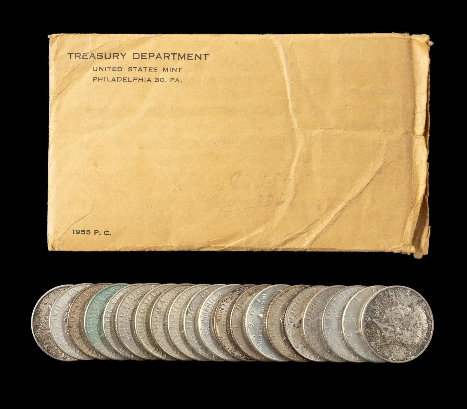 1955 Mint Set and Silver Half Dollars: A 1955 mint set sealed in original cellophane and original envelope open at one end. Four 90% silver Franklin and Kennedy halves and sixteen 40% silver halves