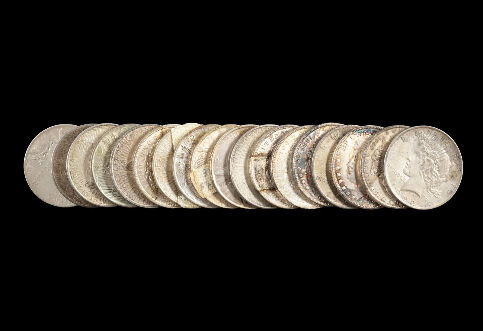 Eighteen Silver Morgan And Peace Dollars: Common dates with some better grades.