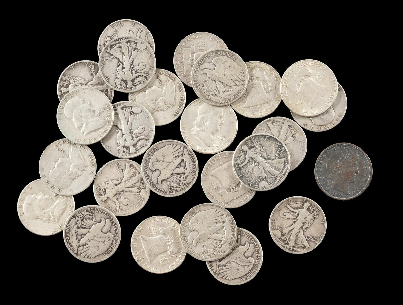Twenty Five Franklin Walking Liberty And 1898 Barber Silver Half Dollars: The 1898 Barber half has good surfaces and grades VF to XF. It has a small field scratch obverse right side. The remaining coins are Franklin and Walking Liberty common dates. 