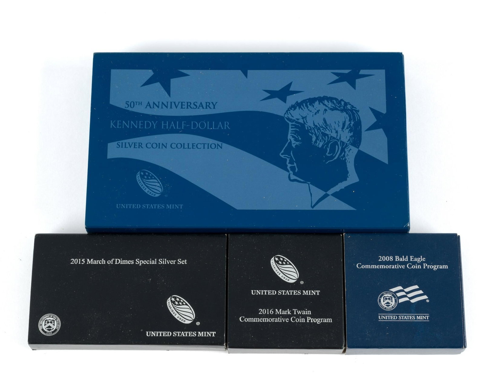 United States Mint Silver Dollar Sets: 2016 proof Mark Twain silver dollar, 2015 March of Dimes proof set with two silver dimes and one silver dollar, 2008 Bald Eagle proof silver dollar, and Kennedy 50th Anniversary four silver half dolla
