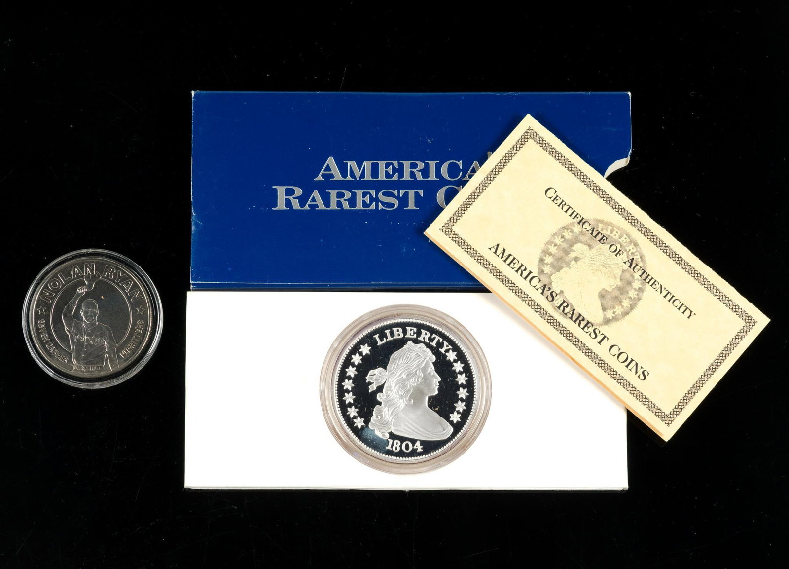 Two Ounce Pure Silver Bullion Coin: A medallion in the manner of the 1804 draped bust dollar .999 fine two troy ounces. Also a 1993 Republic Of Liberia one dollar coin commemorating Nolan Ryan (non-silver). 