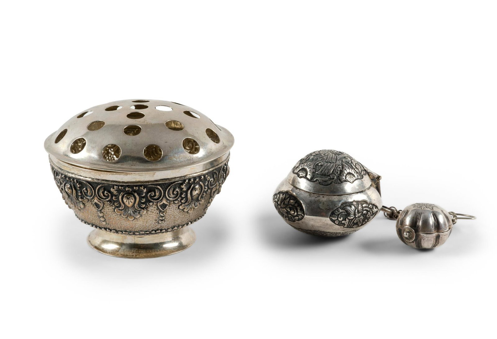 800 Silver Djokja Bowl and Betel Boxes: A 5" diameter Djokja Indonesian silver antique rose bowl with a lid with circular openings which could serve as a flower frog or potpourri bowl. Repousse betel nut or leaf and lime paste boxes in unma
