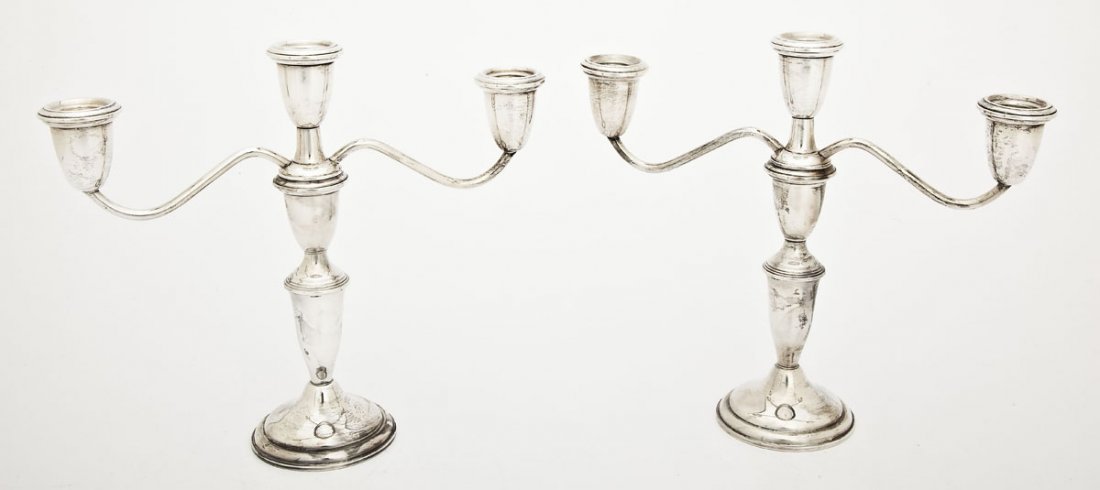 Pair of Empire Sterling Silver Candlesticks: DESCRIPTION: Pair of Empire sterling silver candelabras. Two arms each with three cups, one on each arm and one in the center. Each marked on the bottom "Empire Sterling Weighted 620". MEASUREMENTS: B