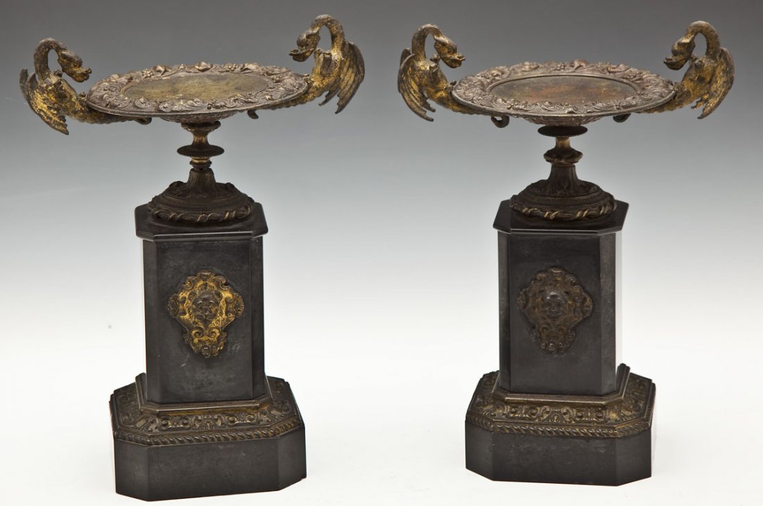 Pair of Dragon Handled Garnitures: DESCRIPTION: Pair of garnitures. Gilt bronze urns with figural dragon form handles resting on black slate bases with lions. 19th century. MEASUREMENTS: Each 11-1/2" high. CONDITION: One with repair to