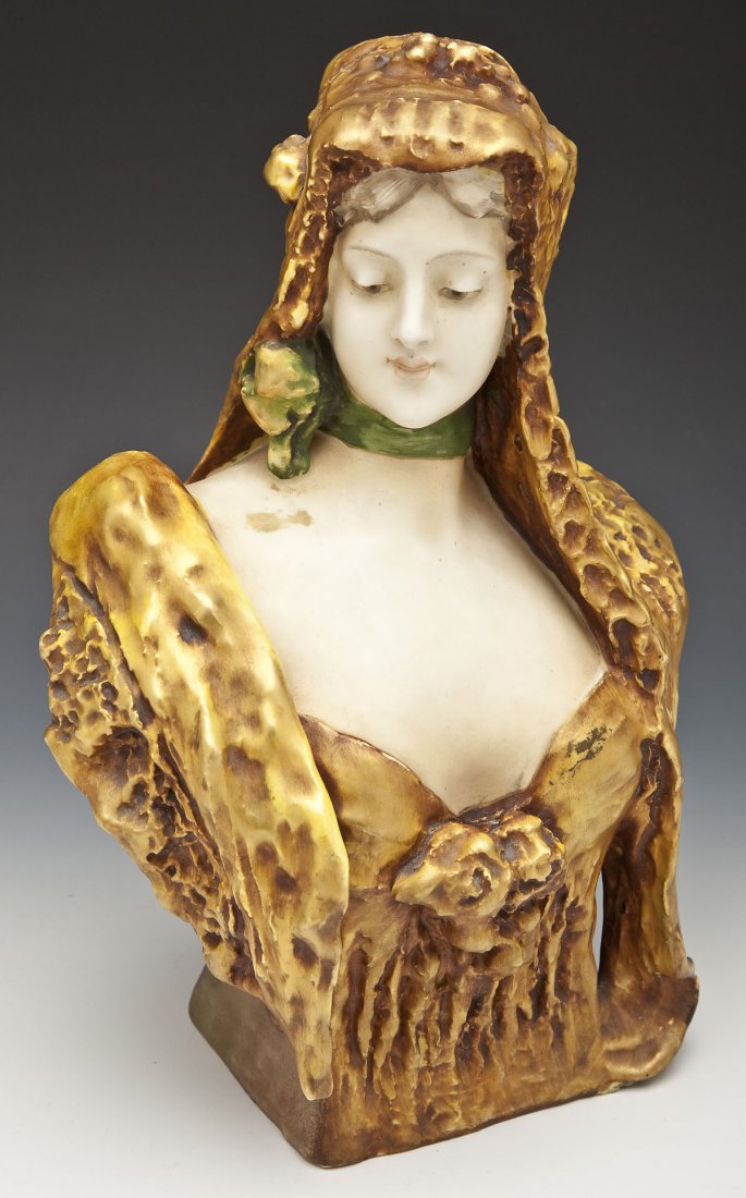 Art Nouveau Amphora Bust: DESCRIPTION: Art Nouveau Amphora Austria Turn-Teplitz bust. Bust of veiled woman with green bow around her neck and a sweetheart neckline with a bouquet in the middle. Signed on the back by artist "W.