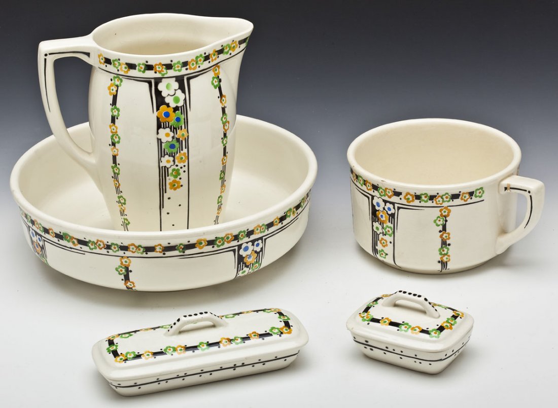5 Pc Art Deco Wash Set: DESCRIPTION: Five piece Art Deco wash set. Cream background with black lines under green, yellow, and blue flowers. Includes: a 10-1/2" pitcher, 4-7/8" deep chamber pot, 14-1/4" wash basin, 5-1/8" x 3