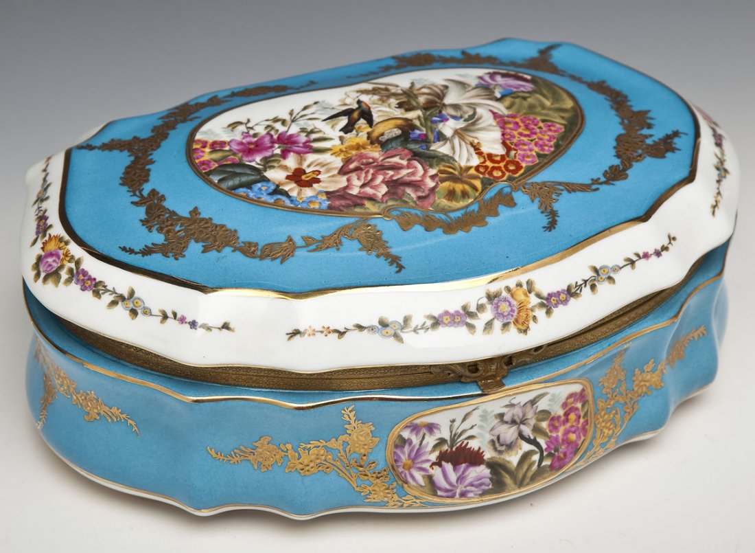 Sevres Porcelain Dresser Box: DESCRIPTION: Sevres porcelain dresser box with ormolu mounts. Turquoise ground with gilded details in a floral and leaf motif flanking painted scenes of birds and flowers. Marked on the bottom with Se