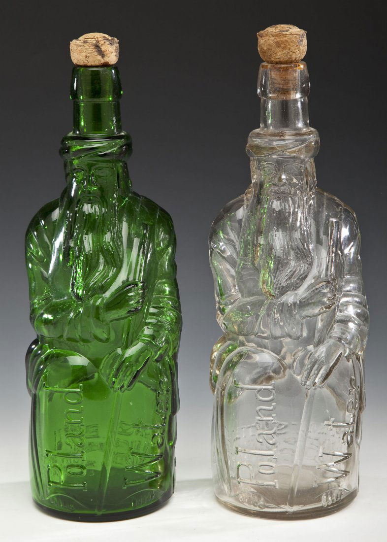 2 Poland Water Fac-Simile Moses Bottles: DESCRIPTION: Two Poland Water Moses bottles. One clear and one green, both with cork stoppers. Both marked on back "Poland Mineral Spring Water" and "The Moses Bottle Fac-Simile of First Poland Water