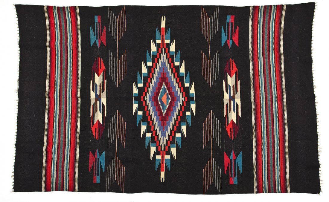 1930's Ortega Chimayo Blanket: DESCRIPTION: Chimayo 100% wool blanket. Circa 1930. Black ground with a pattern of concentric multicolored diamonds. Attributed to the Ortega family of weavers. MEASUREMENTS: 4'1" x 6'7-1/2". CONDITIO