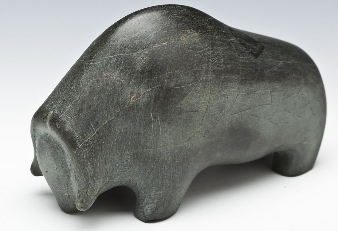 Inuit Sculpture Muskox: DESCRIPTION: Inuit sculpture of a muskox. Marked with syllabics and coop number "C-31-004". MEASUREMENTS: 6-1/2" x 3-1/8" x 4-1/2" high. CONDITION: Mark from tape on back.