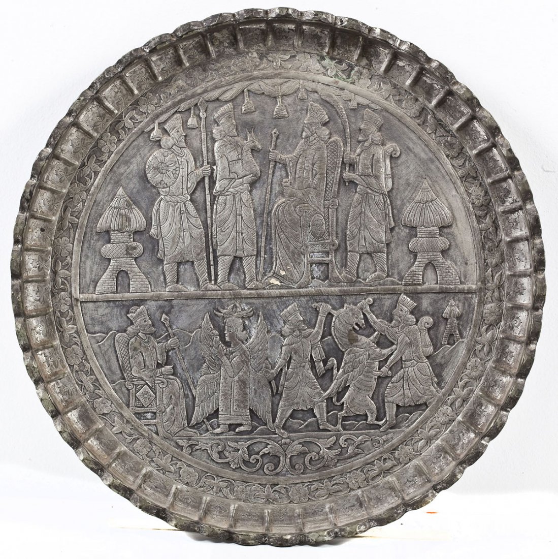 Persian Silvered Copper Charger: DESCRIPTION: Persian silvered copper charger depicting kings with attendants being presented with gifts in relief. Lobed rim, with hammered and carved detailing, and border of flowers. MEASUREMENTS: 1