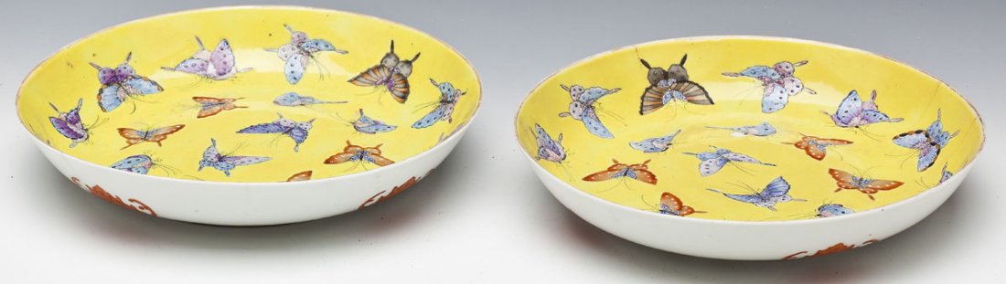 Pair of Chinese Famille Jaune Bowls: DESCRIPTION: Pair of Chinese famille jaune bowls. Interiors with pattern of colored butterflies on a yellow ground. Exteriors with iron red bats. Marked on the bottom with "Tongzhi Nian Zhi" mark but 