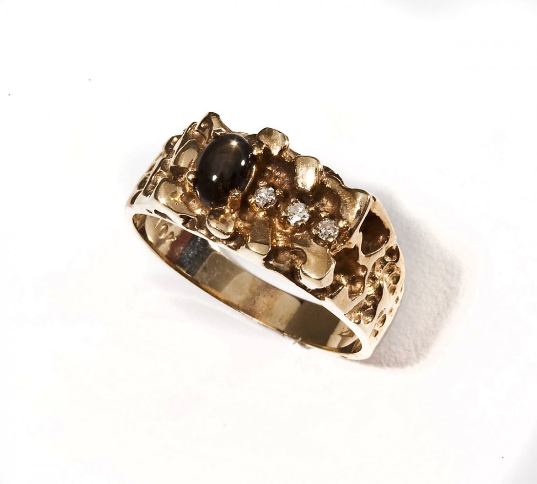 10K Diamond & Star Sapphire Ring: DESCRIPTION: Man's marked 10K yellow gold ring with nugget top set with oval black star sapphire and three approximately .02 carat round diamonds. Size 10. 4.1 dwt (6.4 gr).
