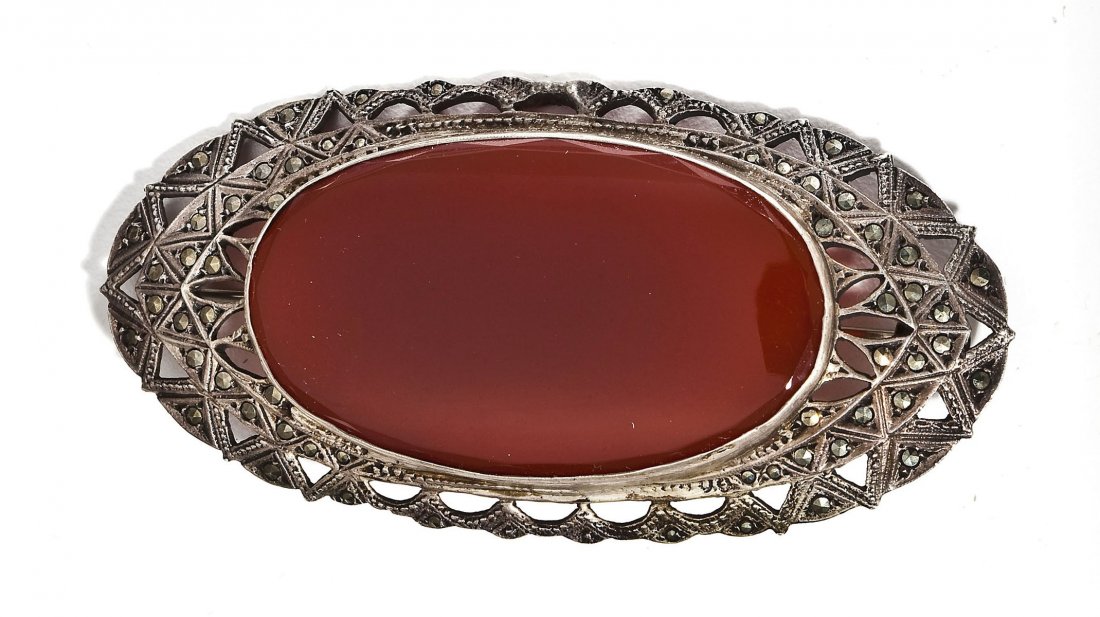 Vintage Carnelian & Marcasite Brooch: DESCRIPTION: Vintage oval brooch with marcasites in tested silver surrounding a 47mm x 27mm oval carnelian. 3" x 1-1/2".