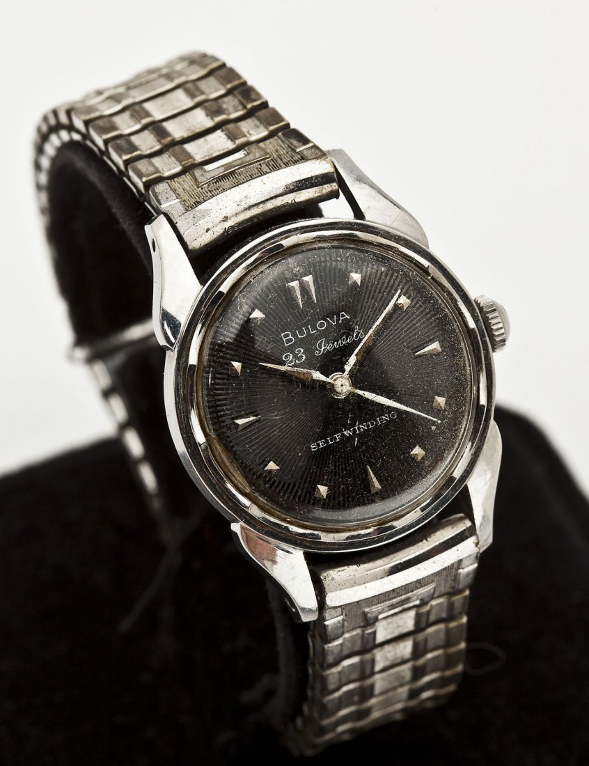 Bulova 23J Self Winding Wristwatch: DESCRIPTION: Man's Bulova wristwatch. Black sunburst dial with silver numeral markers, sweep seconds, marked "Bulova 23 Jewels Self-Winding". Back cover marked "Bulova Stainless Steel Shock Resistant 