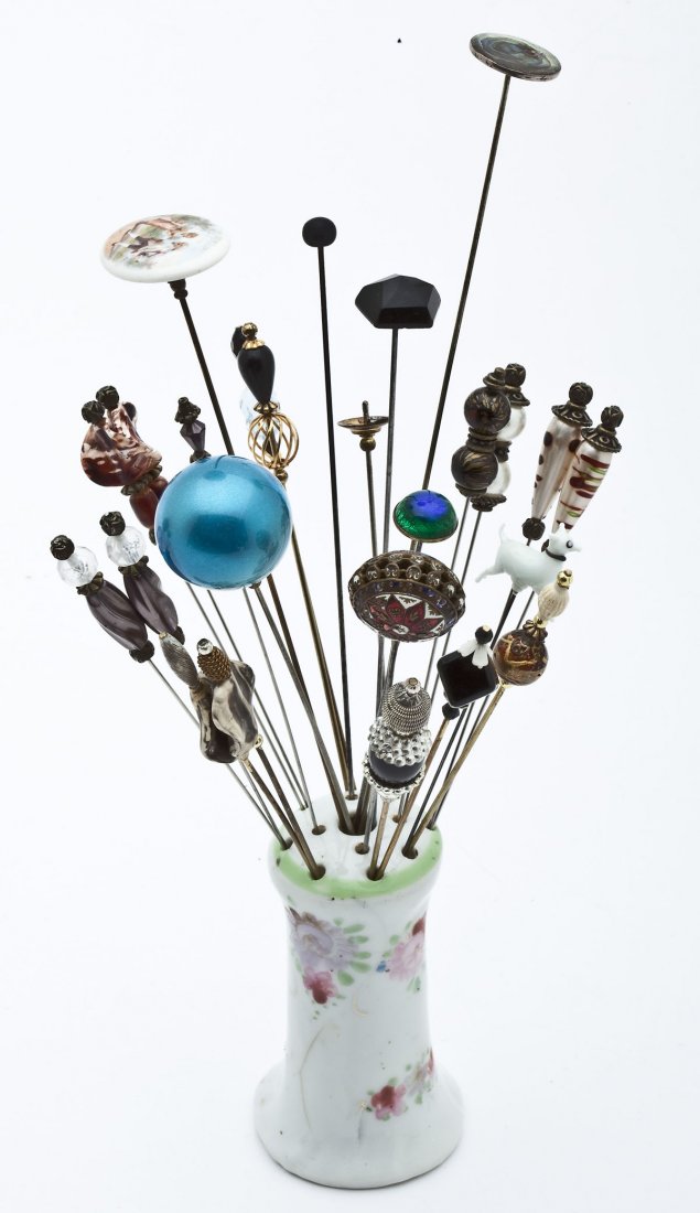 26 Antique & Vintage Hat Pins: DESCRIPTION: Lot of twenty-six antique and vintage hat pins of various materials including: beads, glass stones, pictorial porcelain, porcelain dog, and more. With painted porcelain hat pin holder. Ra