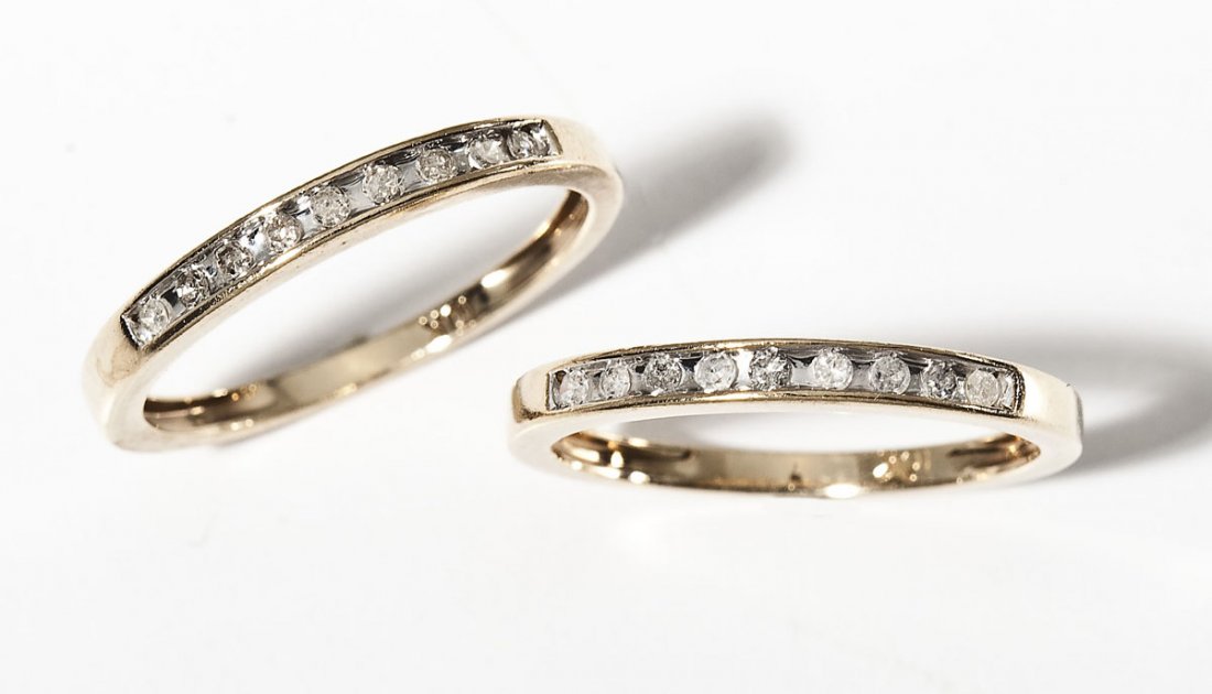 2 10K & Diamond Band Rings .54 CTW: DESCRIPTION: Two diamond band rings in marked 10K yellow gold. Each set with nine approximately 3 point round diamonds. Approximately .54 ctw. Size 7. 1.0 dwt (1.5 gr) total.