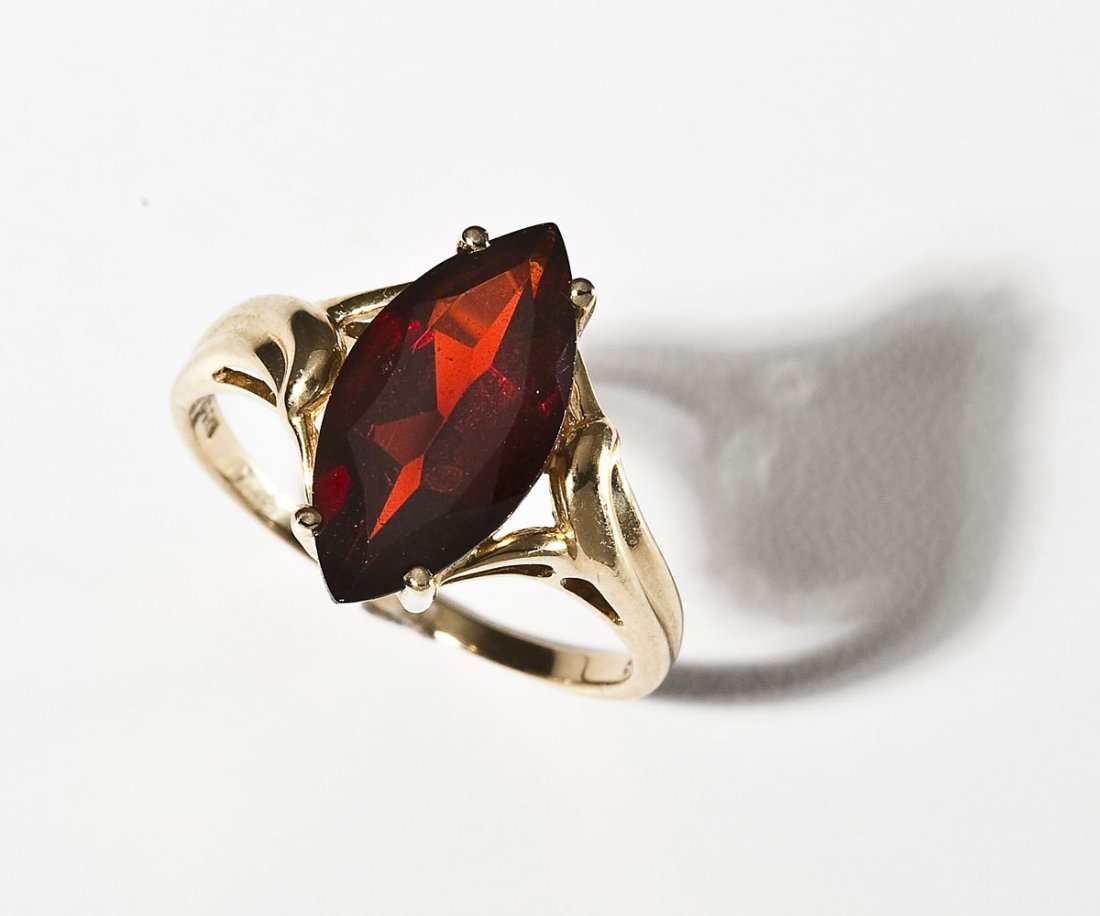 14K & Garnet Ring: DESCRIPTIONI: Ring in marked 14K yellow gold set with one approximately 16mm x 8mm marquise shaped garnet. Size 9. 2.2 dwt (3.5 gr).