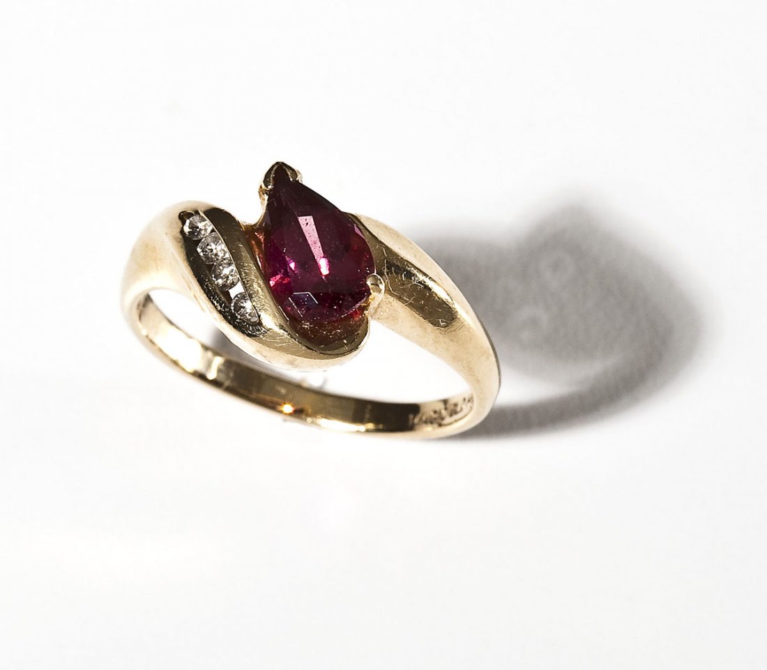 14K Rhodolite Garnet & Diamond Ring: DESCRIPTION: Ring in marked 14K yellow gold set with one pear shaped rhodolite garnet four approximately 2 point round diamond melee. Size 6-3/4. 2.2 dwt (3.4 gr).