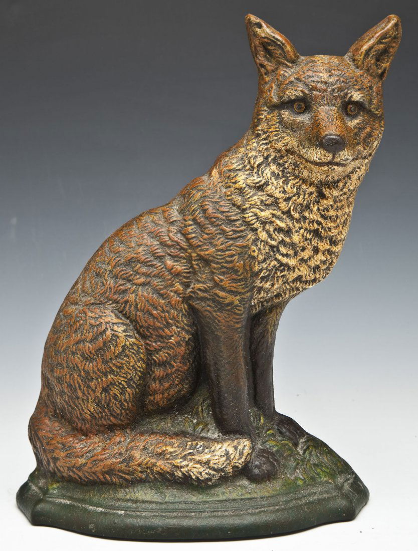 Cast Iron Fox Doorstop: DESCRIPTION: Painted cast iron doorstop of a fox on naturalistic base. Marked "R" to the back of each ear. MEASUREMENTS: 8-1/2" wide x 11-1/2" high. CONDITION: Light overall wear. Paint is complete.