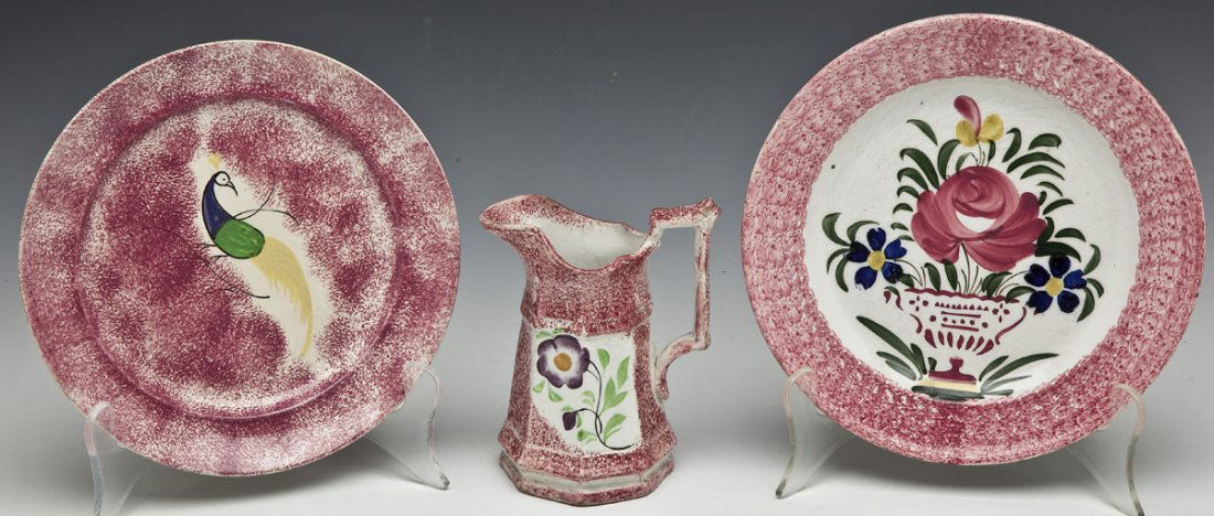 3 Pieces of Spatterware: DESCRIPTION: Three pieces of spatterware including one plate with peacock, one plate with basket of flowers marked "Saint Clement" and one creamer with flowers. MEASUREMENTS: Plates 8-1/4" to 8-1/2".