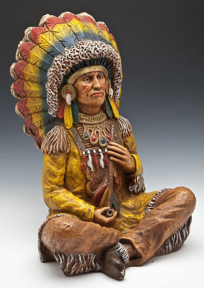 Plaster Cigar Store Figure of Indian Chief: DESCRIPTION: Painted plaster cigar store figure of a seated Indian chief. Early 20th century. MEASUREMENTS: 20" high. CONDITION: Minor wear, repair to foot.