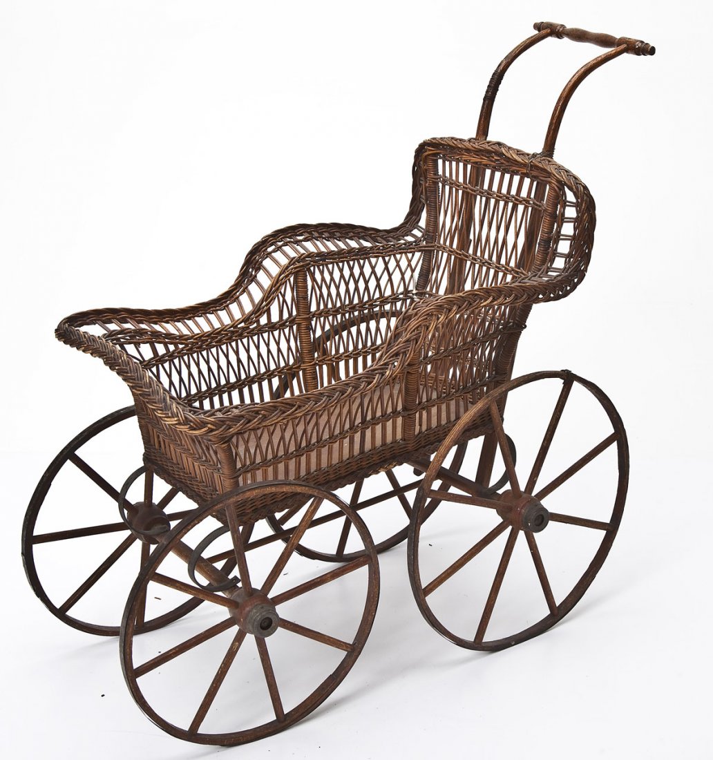 Victorian Wicker Doll Carriage: DESCRIPTION: Victorian wicker doll carriage. Bent wood handle. Wood wheels and metal springs. MEASUREMENTS: 30" long x 28-3/4" high. CONDITION: Overall wear and patina as expected with age.