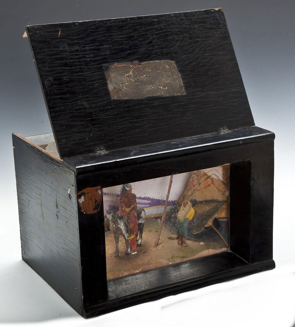 Museum Diorama Indian Family Sioux: DESCRIPTION: Museum diorama of an Indian Family Sioux as labeled to top. Housed in a black painted wood and glass box. MEASUREMENTS: 12-1/2" wide x 9-1/2" deep x 8-3/4" high. CONDITION: Overall wear.