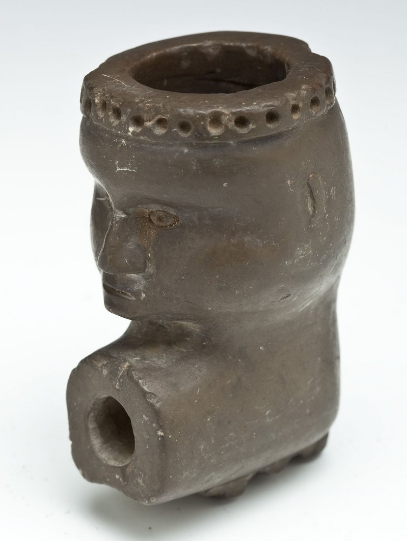 Native American Steatite Effigy Pipe: DESCRIPTION: Native American effigy pipe of gray-green steatite having a human face bowl. MEASUREMENTS: 2-5/8" long. CONDITION: Some wear as expected with two small chips to back of rim.