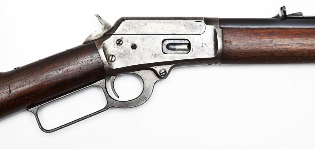 Marlin Model 1894 Rifle - .38-40 WCF: SERIAL #: 122092 DESIGN: Lever action with full length tubular magazine. 24" round barrel. MATERIAL/FINISH COMPOSITION: Blued steel. Case hardened receiver. Wood straight stock and forearm. FEATURES: 