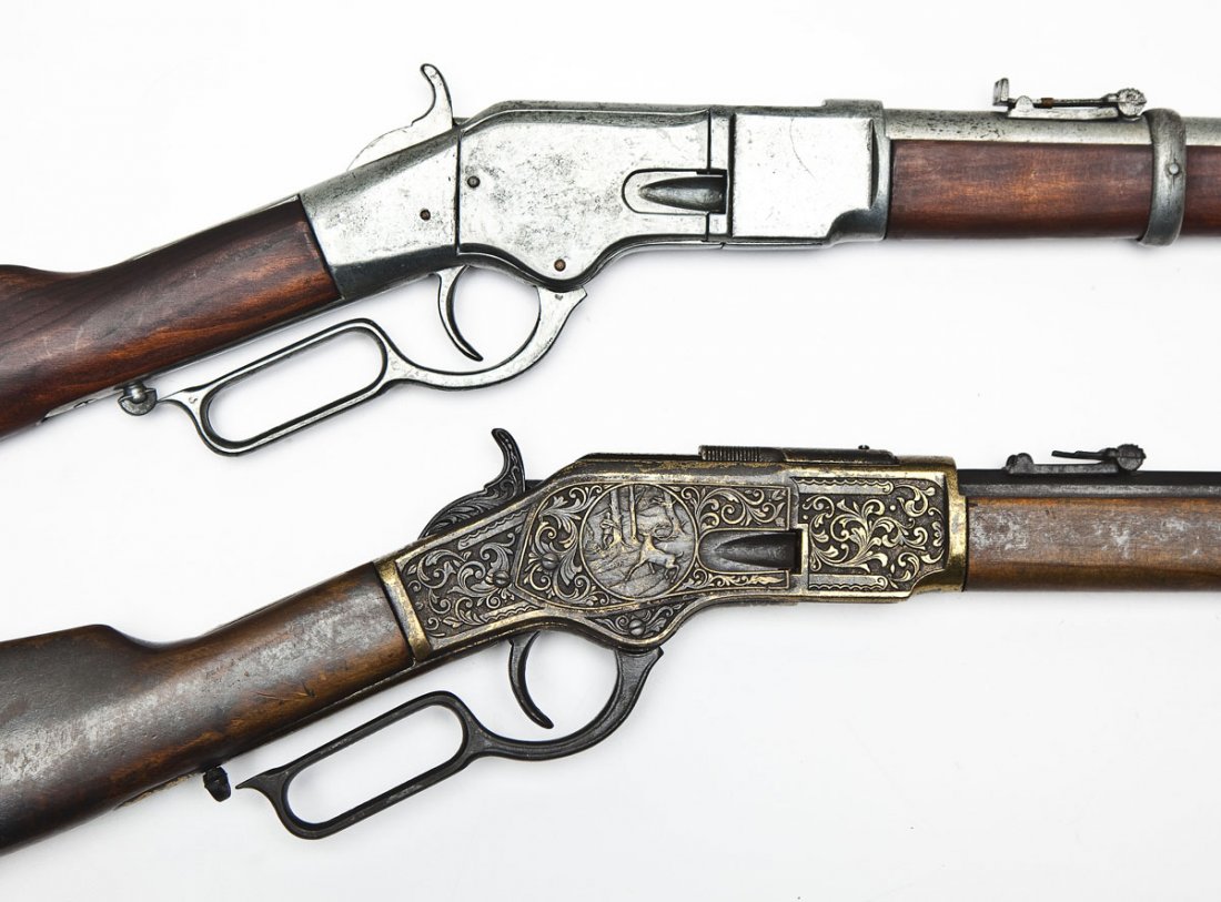 2 Winchester Lever Action Prop Rifles: DESCRIPTION: Reproductions of Winchester lever action rifles with full length tubular magazines. 1) Made from pewter type metal with 24" round barrel. Wood straight stock and forearm. 2) Made from blu