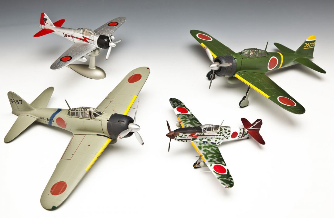 4 Japanese WWII Model Planes: DESCRIPTION: Four Japanese WWII model planes. Includes: 3 Japanese Zeros, marked "870", "170", and "45" respectively, and a dive bomber with stand. Zeros by 21st Century Toys, bomber by NewRay. MEASUR