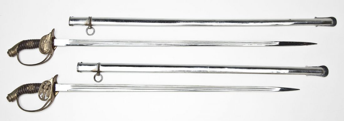 2 Reproduction Prussian Dress Swords: DESCRIPTION: Reproductions of two Prussian dress swords. Double fullered plated blades. Wire wrapped grips with the Prussian insignia. Plated hand guards with folding clamshells at cross guards. Plate