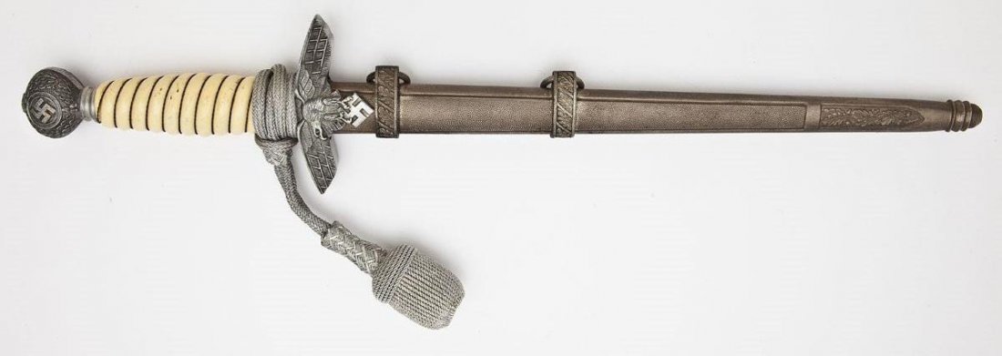 WWII German Luftwaffe Second Model Dagger: DESCRIPTION: WWII German Luftwaffe second model dagger with silver colored portepee and scabbard. Wire wrapped ivory colored celluloid grip. MEASUREMENTS: Blade length 10". Overall length 15-1/4". CON