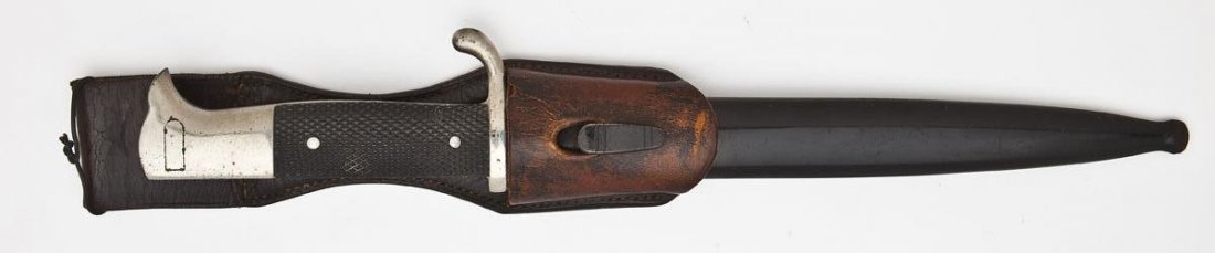WWII Era K-98 Dress Bayonet with Frog: DESCRIPTION: WWII era K-98 dress bayonet with frog. Bayonet lug channel is red felt lined, which designates artillery. Checkered black plastic grip. Made and marked by "Alcoso/Solingen". MEASUREMENTS: