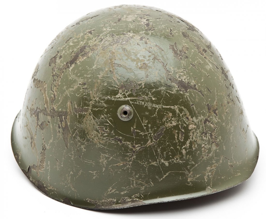 WWII Era Italian Military Helmet: DESCRIPTION: WWII era Italian military helmet with original liner and chinstrap. MEASUREMENTS: 10-1/2" x 9" x 6" high. CONDITION: Significant scratching to green paint on surface and chinstrap is fray