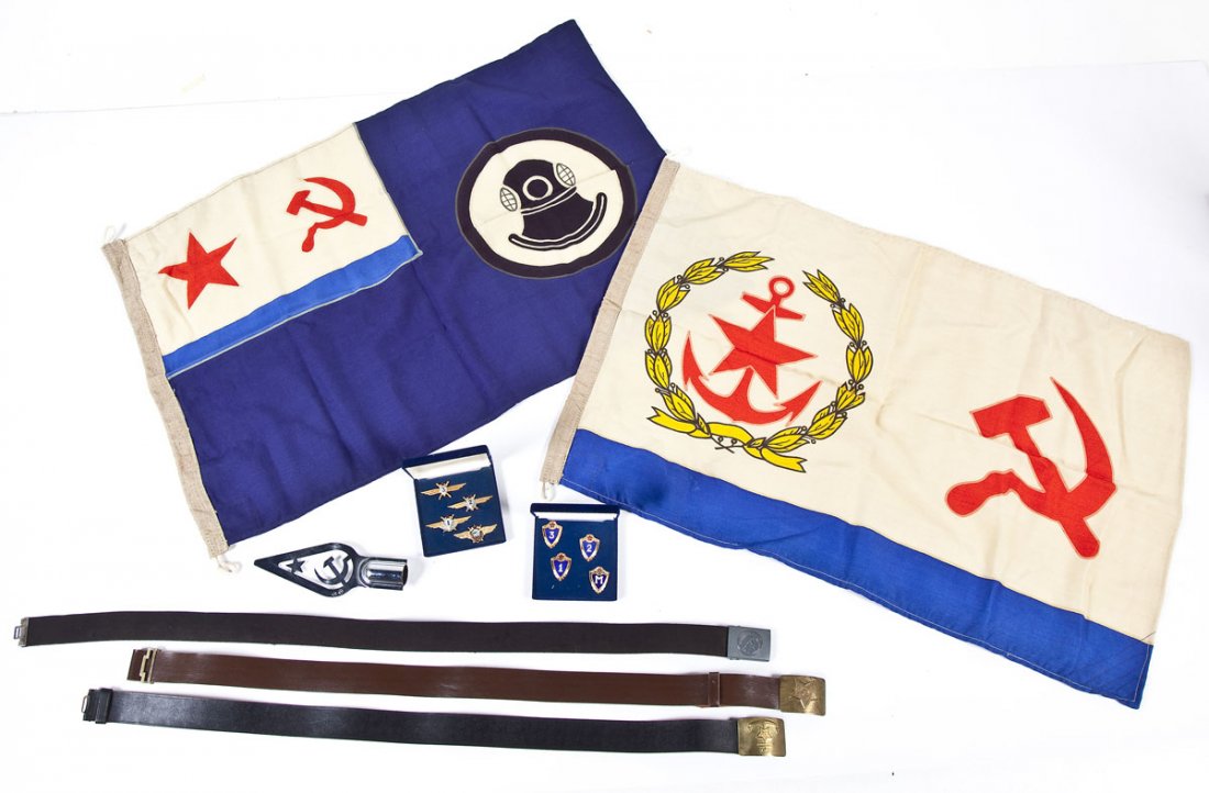 Collection of Soviet Military Items: DESCRIPTION: Collection of Soviet military items. Including: 3 belts with Soviet marked buckles, one Soviet flagpole end, 2 display cases of insignia, and 2 Naval flags, one Flag of Chief of the Main 