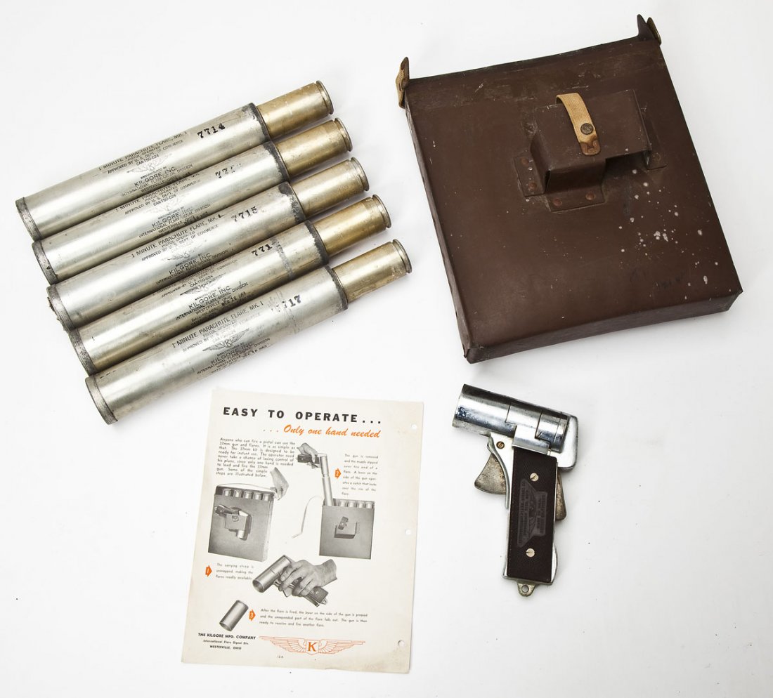 One Minute Parachute Flare Gun Kit: DESCRIPTION: One minute parachute flare gun kit made by International Flare-Signal Co. Includes: flare pistol, 5 flares, and case with carrying strap. MEASUREMENTS: Diameter of boar 1-5/8". Flare cart