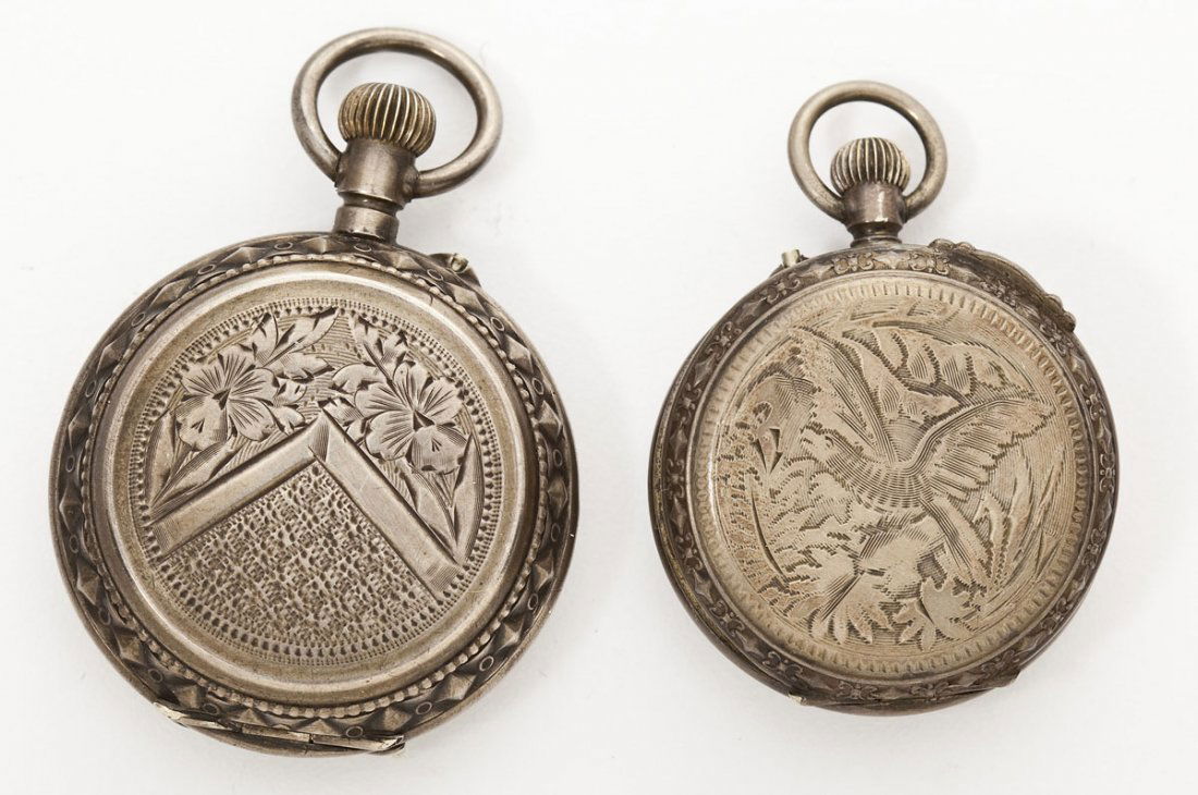 2 Lady's Pendant Watches: DESCRIPTION: Two lady's silver pendant watches. Includes: 1) One silver pocket watch with bird and forest design to back cover. Porcelain face with Roman numerals. Inside case marked "Switzerland 2711