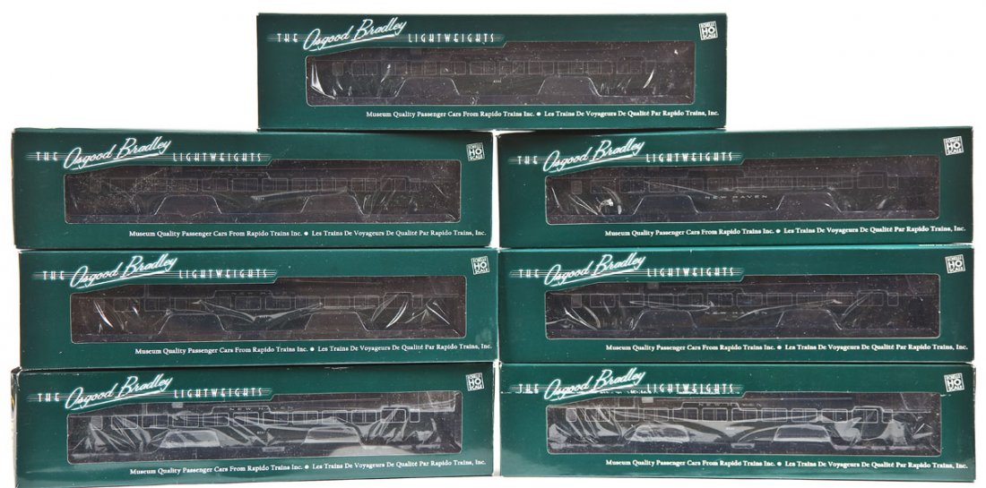 7 Rapido Osgood Bradley New Haven Passenger Cars: DESCRIPTION: Seven Rapido Osgood Bradley New Haven hunter green passenger cars. HO scale. CONDITION: Appear unused in original boxes.