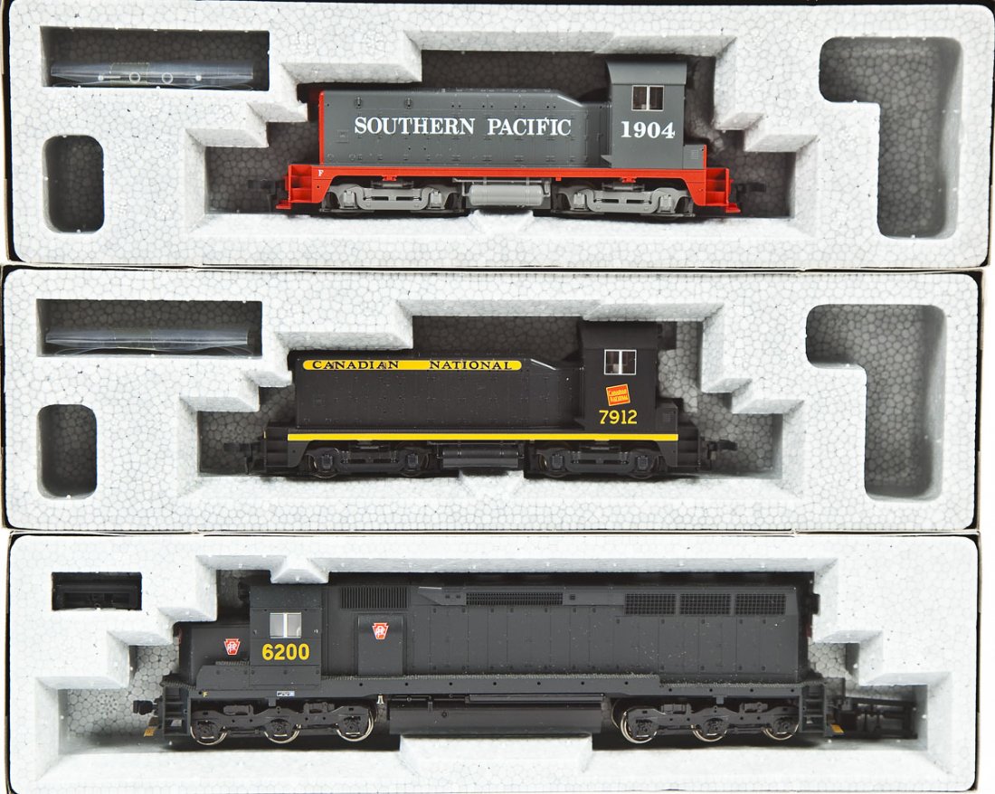 3 Kato HO Locomotives: DESCRIPTION: Three Kato locomotives including CN #7912, SP #1904, and Pennsylvania #6200. HO scale. CONDITION: Appear unused in original boxes.