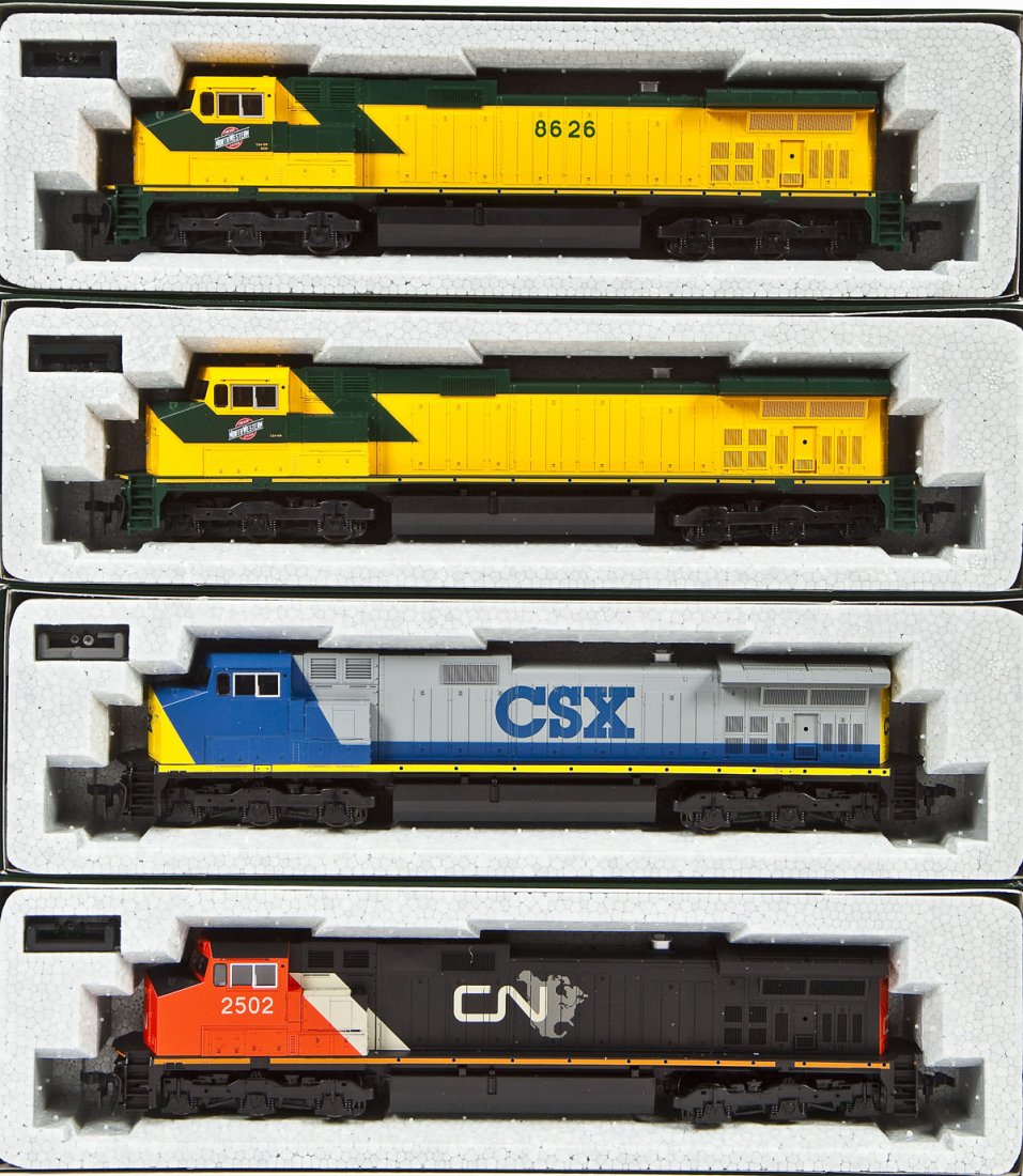 4 Kato C44-9W Locomotives: DESCRIPTION: Four Kato C44-9W locomotives including CN #2502, CSX (unnumbered), CNN (unnumbered), and CNN #8626. HO scale. CONDITION: Appear unused in original boxes.