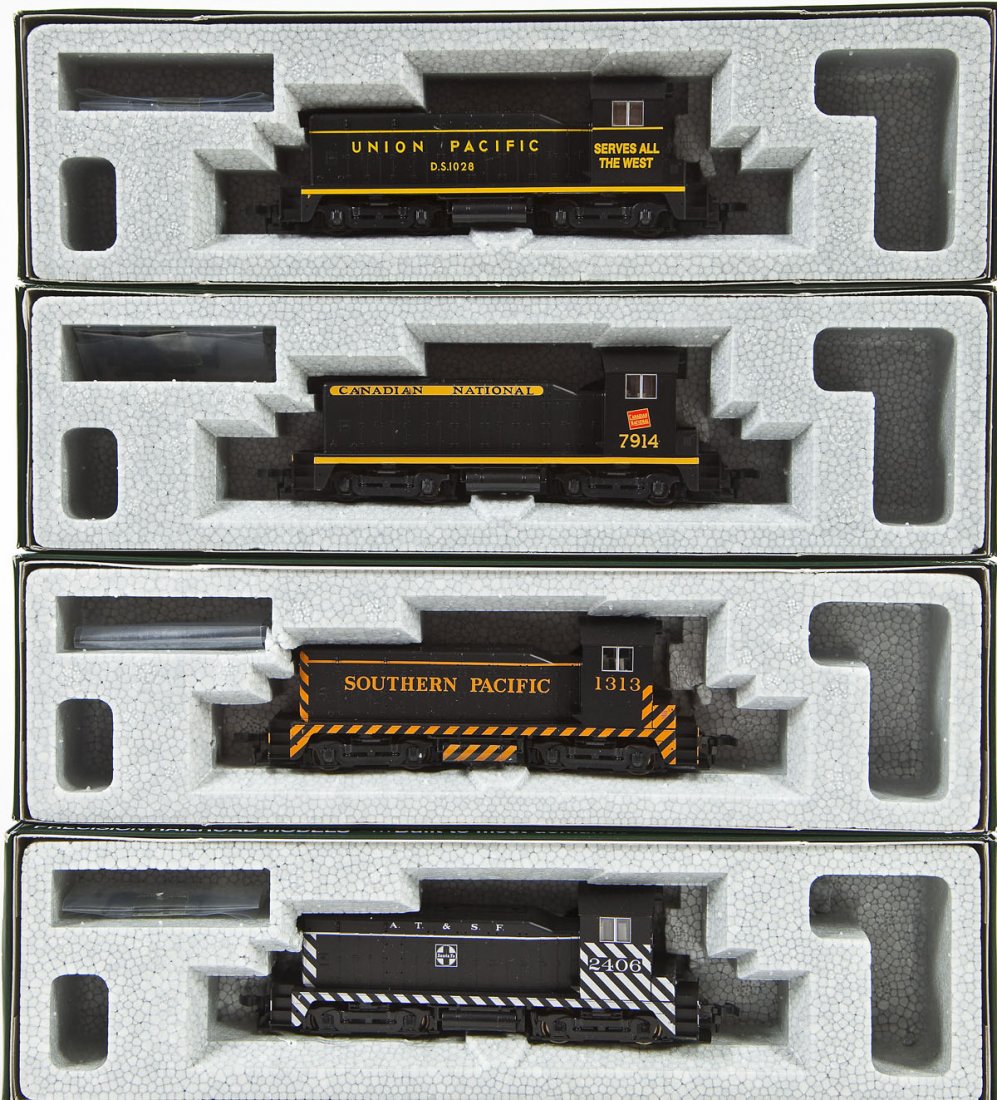 4 Kato NW2 Locomotives: DESCRIPTION: Four Kato NW2 locomotives including SF #2406, SP #1313, UP #1028, and CN #7914. HO scale. CONDITION: Appear unused in original boxes.