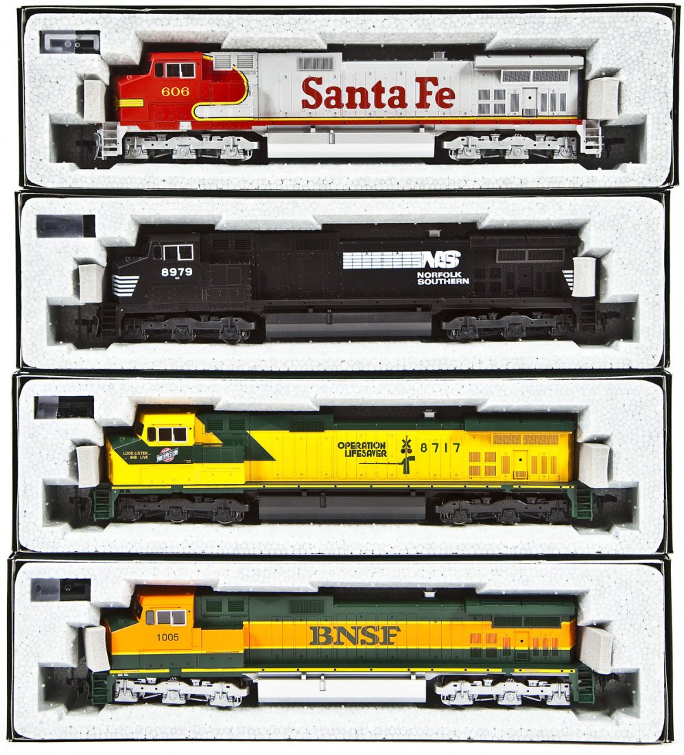 4 Kato C44-9W Locomotives: DESCRIPTION: Four Kato C44-9W locomotives including CNW Operation Lifesaver #8717, BNSF #1005, SF #606, and NS #8979. HO scale. CONDITION: Appear unused in original boxes.