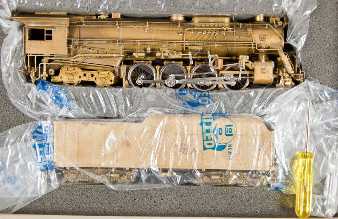 United Scale New Hi-Grade C&O Brass Loco & Tender: DESCRIPTION: United Scale Models New Hi-Grade C&O brass locomotive and tender. HO scale. CONDITION: Appears used with overall patina and small areas of discoloration. Housed in original box.